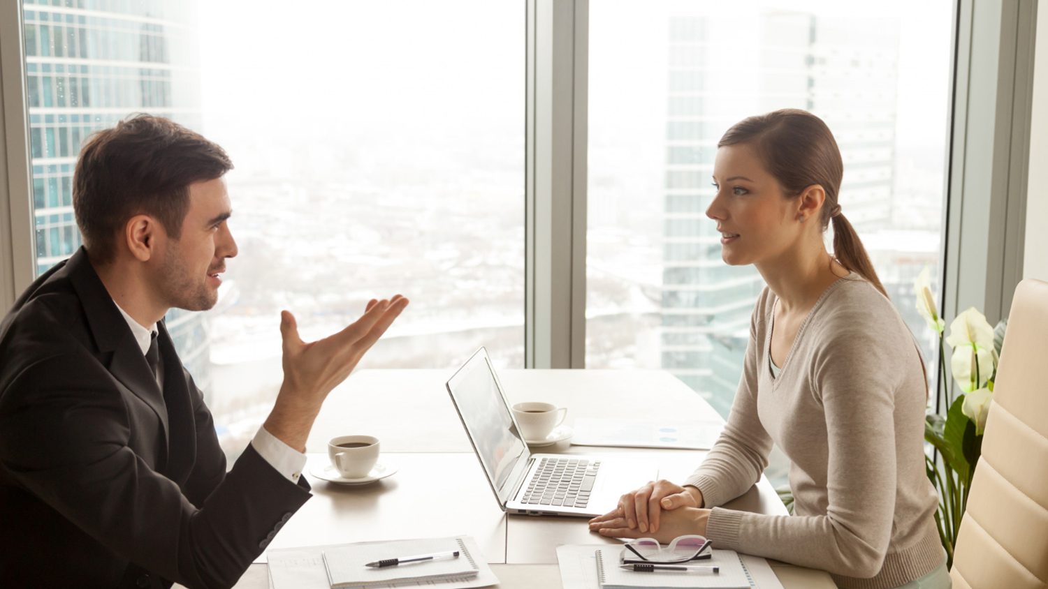 businessman-businesswoman-discussing-work-office-desk